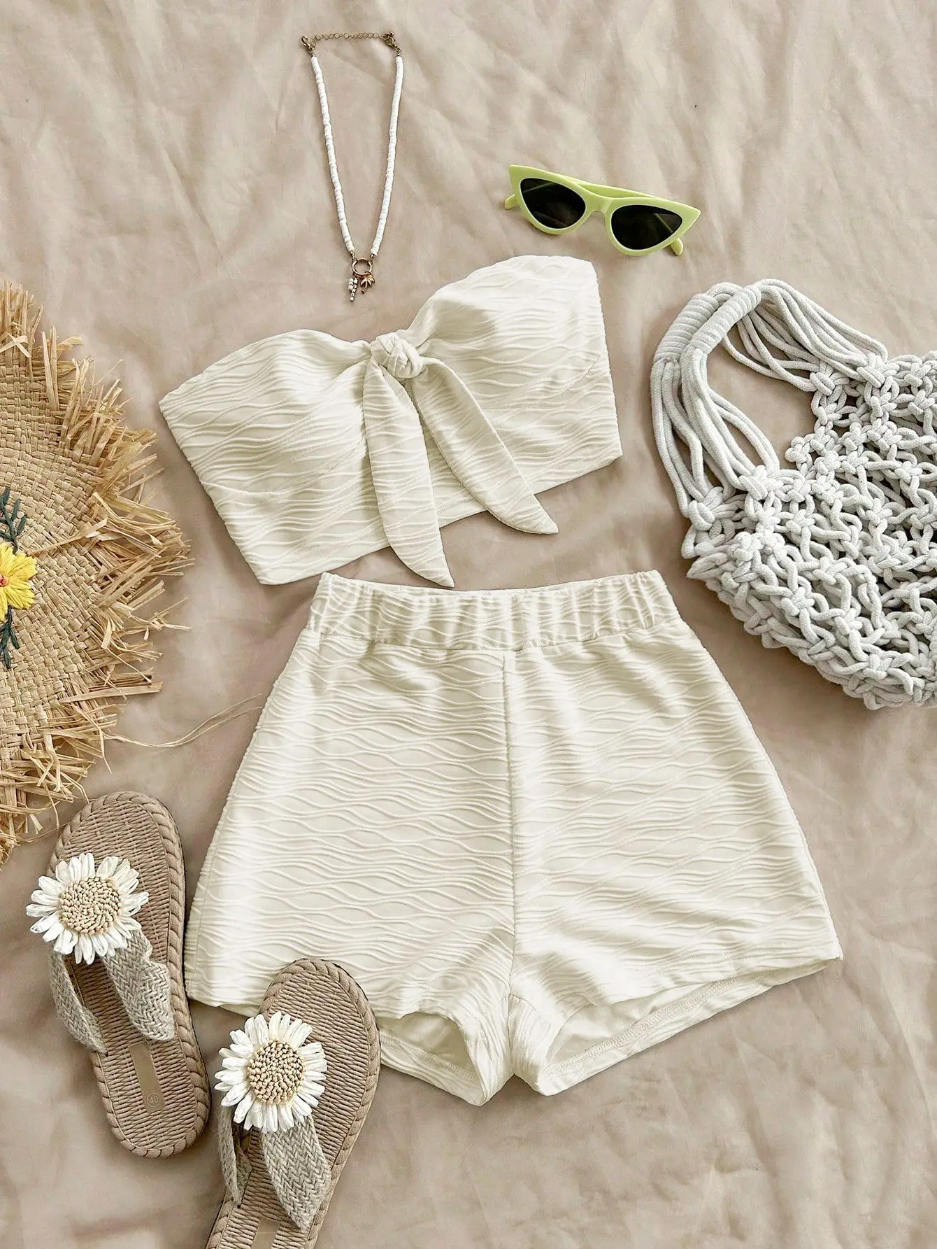Women's summer two-piece set with bow-tie strapless top and shorts, featuring a textured, alluring style.
Women's summer two-piece set with bow-tie strapless top and shorts, featuring a textured, alluring style.