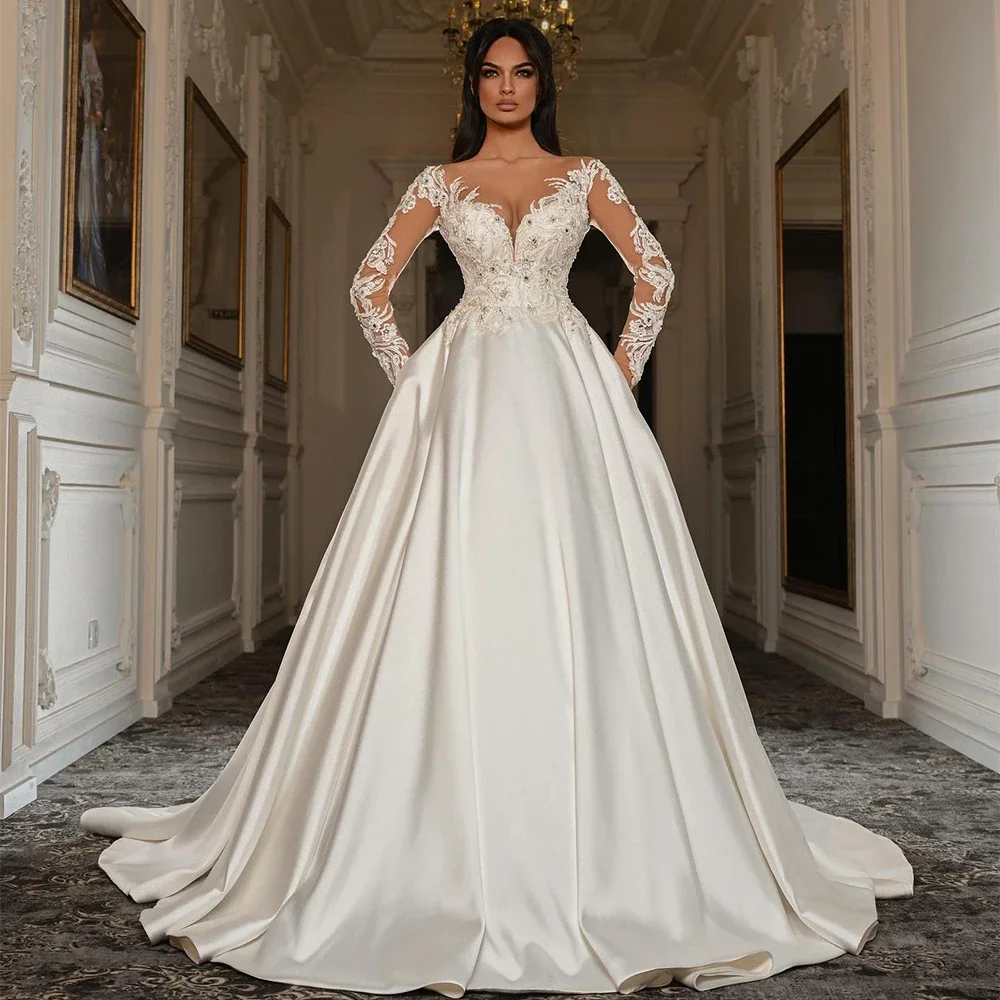 Flavinke Свадебные платья по индивидуальному заказу с длинным рукавом и круглым вырезом, аппликация из бисера, корсет, свадебное платье, атласные платья невесты со шлейфом
Flavinke Свадебные платья по индивидуальному заказу с длинным рукавом и круглым вырезом, аппликация из бисера, корсет, свадебное платье, атласные платья невесты со шлейфом