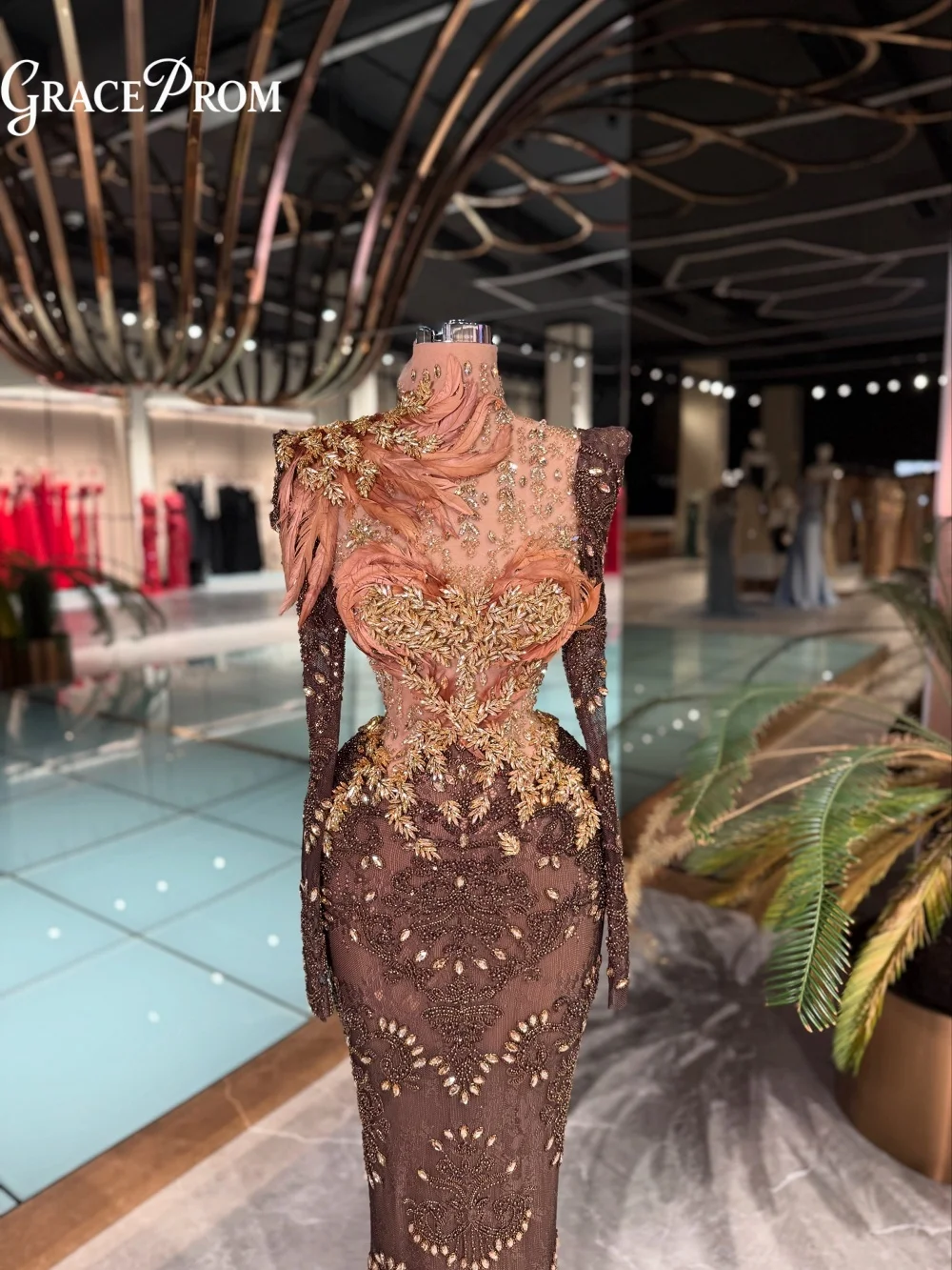 Formal Brown Mermaid Evening Gown with Sheer High Neck Gold 3D Feather Floral Details Party Dress for Wedding Guests فساتين سهرة
Formal Brown Mermaid Evening Gown with Sheer High Neck Gold 3D Feather Floral Details Party Dress for Wedding Guests فساتين سهرة