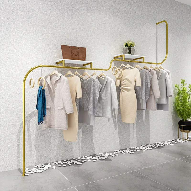 Clothing store display shelves on the wall Stainless steel supports custom hanging clothes shelves Simple and creative women's
Clothing store display shelves on the wall Stainless steel supports custom hanging clothes shelves Simple and creative women's