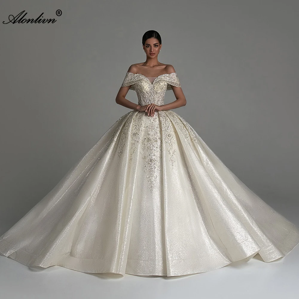 Alonlivn выполненное на заказ блестящее кружево с открытыми плечами и рукавами бальное платье Свадебные платья Кружевные свадебные платья с вышивкой бисером
Alonlivn выполненное на заказ блестящее кружево с открытыми плечами и рукавами бальное платье Свадебные платья Кружевные свадебные платья с вышивкой бисером