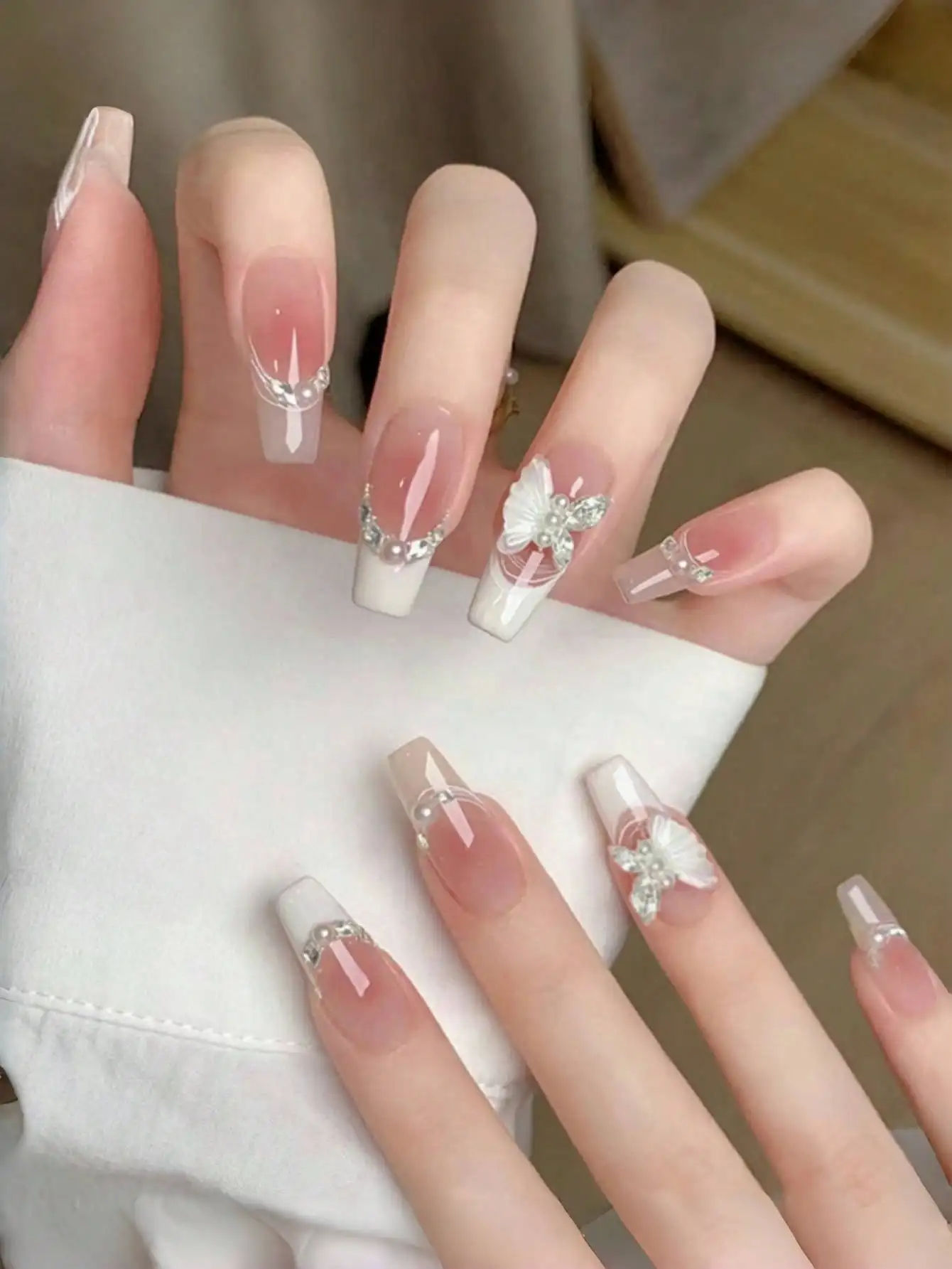 Press-on false nails featuring handmade blush cat-eye, French tip, diamond and butterfly decorations in white French style, manicure supplies
Press-on false nails featuring handmade blush cat-eye, French tip, diamond and butterfly decorations in white French style, manicure supplies
