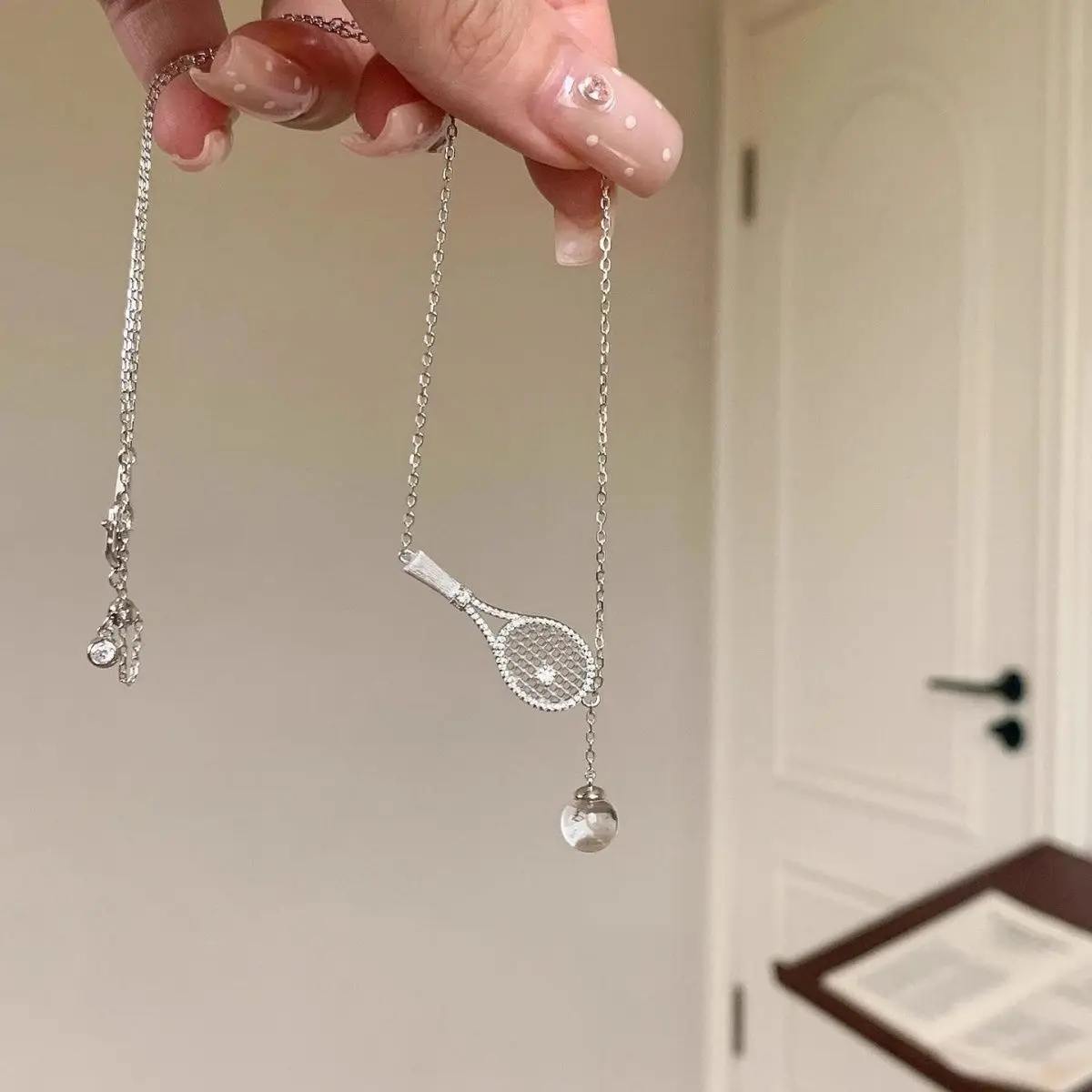 Inlaid wire drawing tennis racket clear white water ball pendant necklace light luxury niche high-end
Inlaid wire drawing tennis racket clear white water ball pendant necklace light luxury niche high-end
