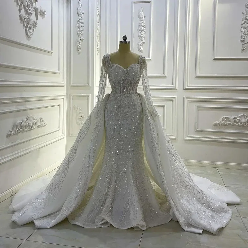 2023 Portrait Mermaid Wedding Dresses With Overskirts Lace Ruched Sparkle Rhinstone Bridal Gowns Dubai Luxury Dresses
2023 Portrait Mermaid Wedding Dresses With Overskirts Lace Ruched Sparkle Rhinstone Bridal Gowns Dubai Luxury Dresses