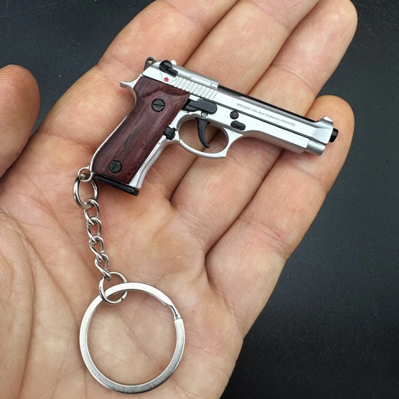 Metal Keychain Pendant with Solid Wood Handle, 1:4 Scale, Creative 92F Gun Model Keychain Ring Accessory for Men.
Metal Keychain Pendant with Solid Wood Handle, 1:4 Scale, Creative 92F Gun Model Keychain Ring Accessory for Men.