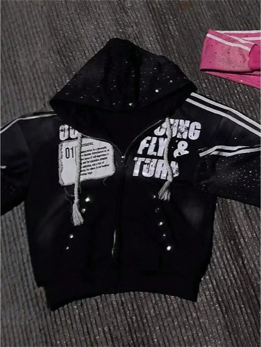Black Hooded Zip-Up Jacket with Distressed Letter Print and Rhinestone Accents
Black Hooded Zip-Up Jacket with Distressed Letter Print and Rhinestone Accents