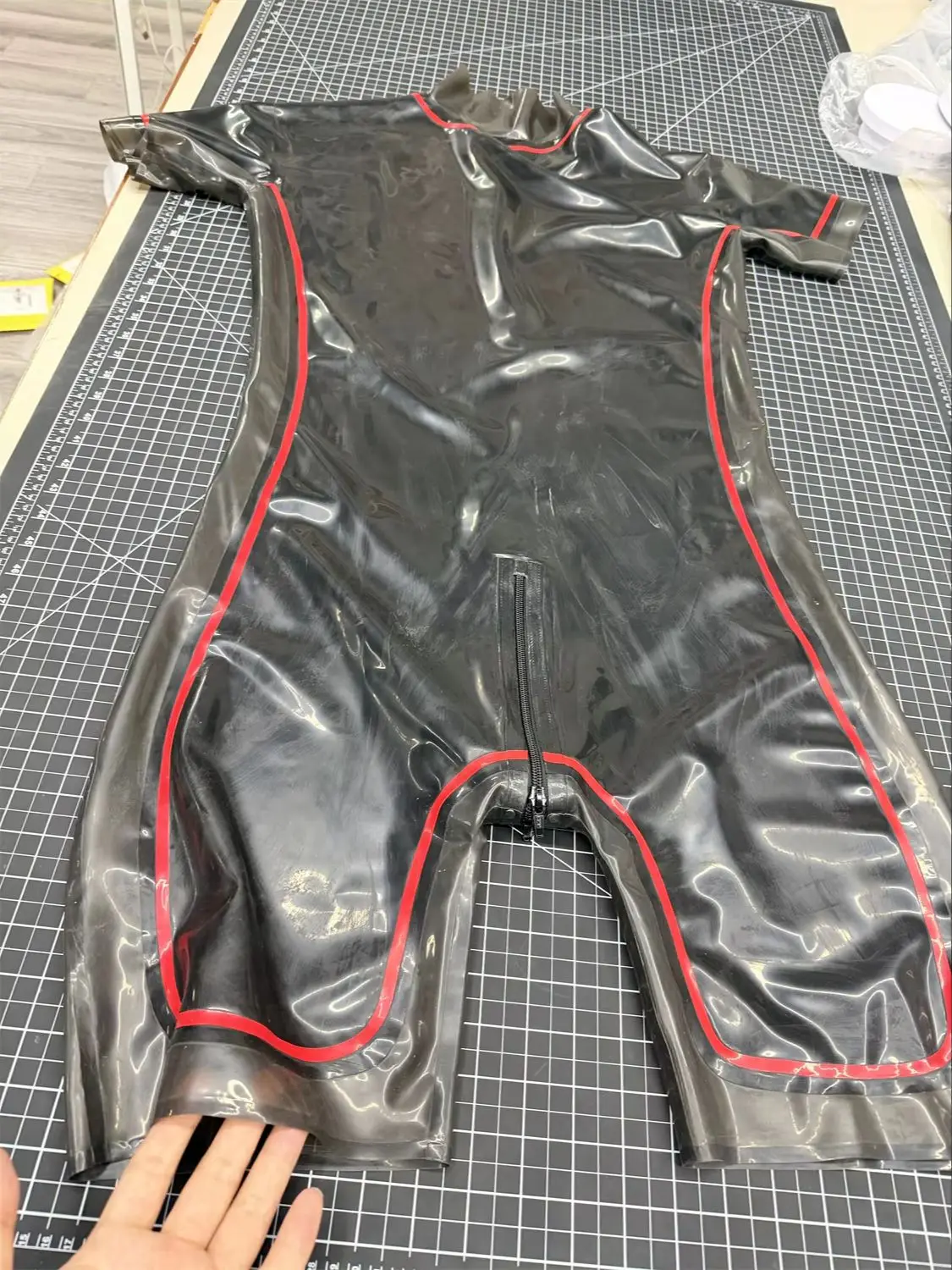 Transparent Black Rubber Catsuit for Men Stretchy Bodysuit with Red Contrast Trim and Convenient Zipper
Transparent Black Rubber Catsuit for Men Stretchy Bodysuit with Red Contrast Trim and Convenient Zipper 