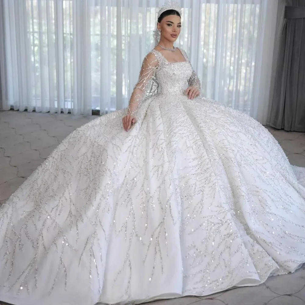 Шикарное свадебное платье принцессы с квадратным вырезом, блестящее, сексуальное, с длинными рукавами, кружевом и жемчужным декором, индивидуальный пошив
Шикарное свадебное платье принцессы с квадратным вырезом, блестящее, сексуальное, с длинными рукавами, кружевом и жемчужным декором, индивидуальный пошив