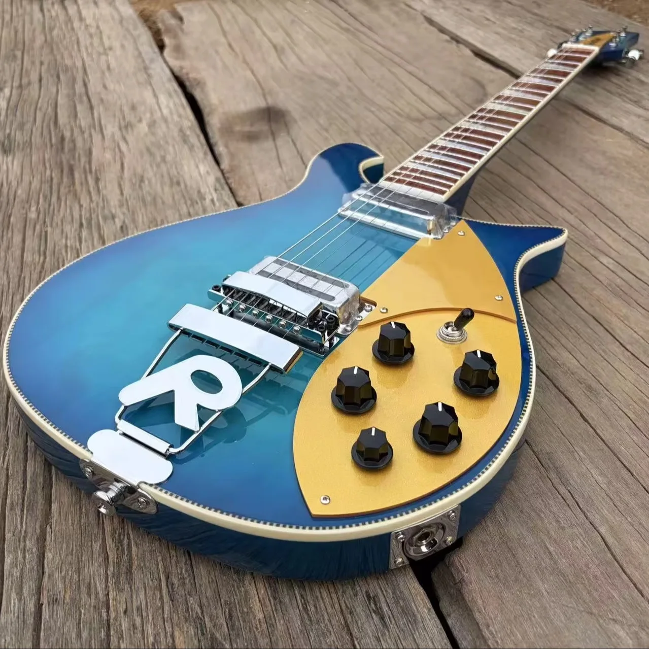 660 6 String Electric Guitar Stainless Steel Frets, Gold Pickguard, R Shaped Tailpiece, Checkerboard Binding, Blue Color Guitar
660 6 String Electric Guitar Stainless Steel Frets, Gold Pickguard, R Shaped Tailpiece, Checkerboard Binding, Blue Color Guitar