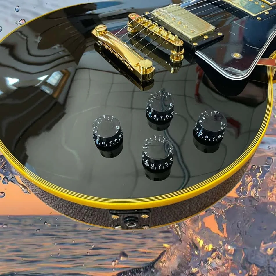 Black electric guitar with rosewood fingerboard, gold hardware, 2H pickups, and mahogany body
Black electric guitar with rosewood fingerboard, gold hardware, 2H pickups, and mahogany body