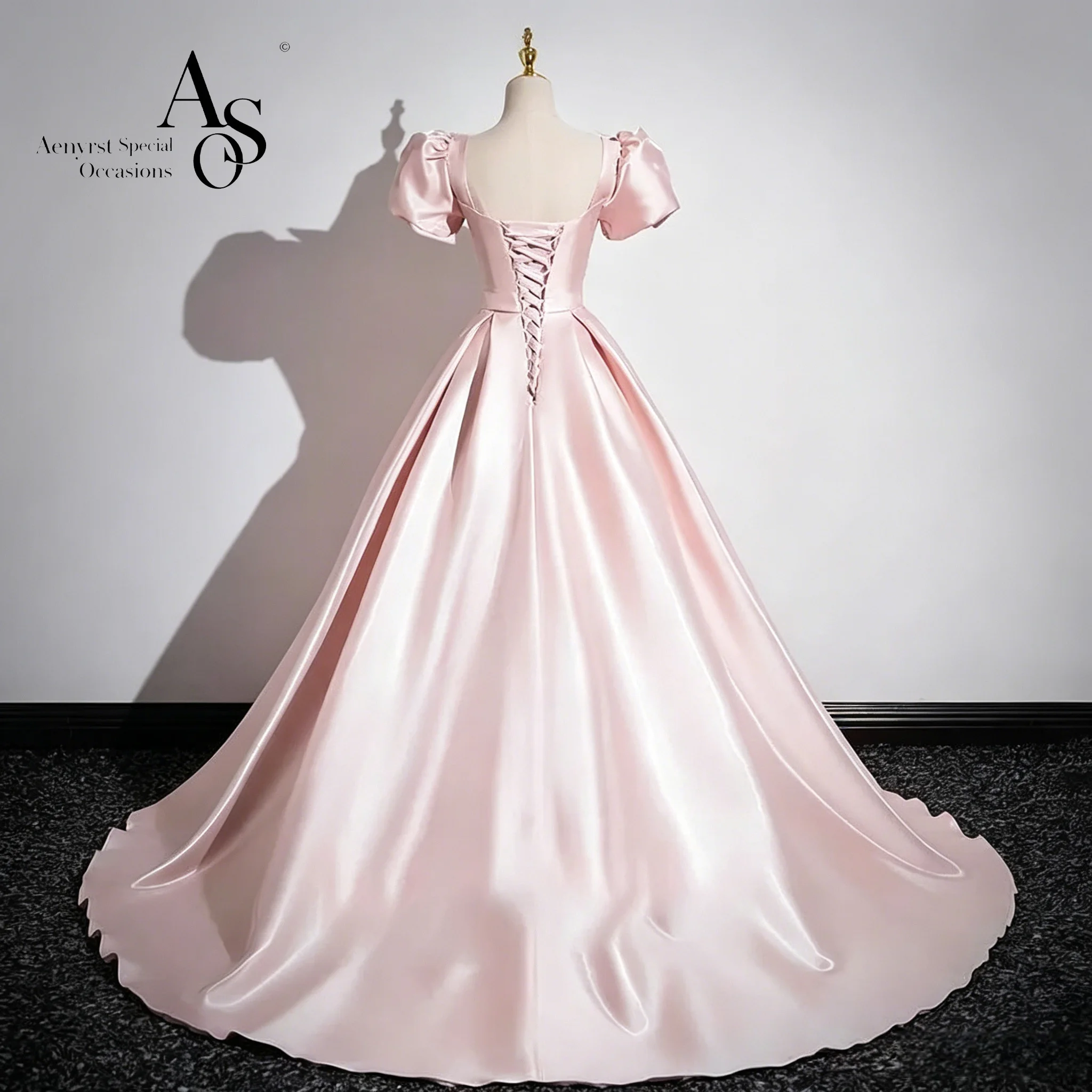 An elegant satin short-sleeved evening gown with a floor-length skirt adorned with a bow and a backless, tie-up design.
An elegant satin short-sleeved evening gown with a floor-length skirt adorned with a bow and a backless, tie-up design.