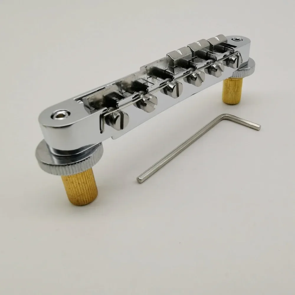 Электрогитарный бридж Matic, 1 комплект, хромированный, с роликовыми седлами Tune-O, для электрогитар LP и SG (BM003), СДЕЛАНО В КОРЕЕ
Электрогитарный бридж Matic, 1 комплект, хромированный, с роликовыми седлами Tune-O, для электрогитар LP и SG (BM003), СДЕЛАНО В КОРЕЕ