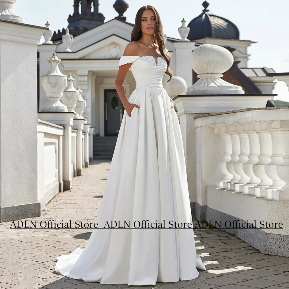 Свадебное платье Vestidos De Novia, новое индивидуальное свадебное платье с открытыми плечами, расшитое жемчугом и скользящим шлейфом, с карманом, на шнуровке сзади
Свадебное платье Vestidos De Novia, новое индивидуальное свадебное платье с открытыми плечами, расшитое жемчугом и скользящим шлейфом, с карманом, на шнуровке сзади