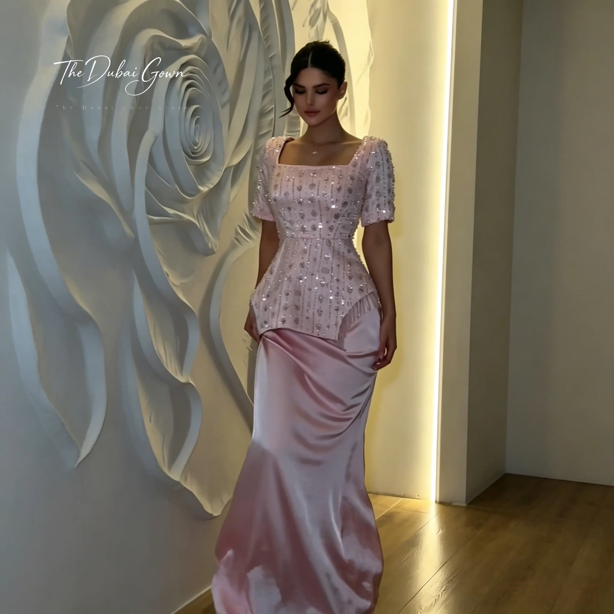 Elegant pink short-sleeved floor-length formal gown featuring a mermaid silhouette beadwork and fringe detailing
Elegant pink short-sleeved floor-length formal gown featuring a mermaid silhouette beadwork and fringe detailing