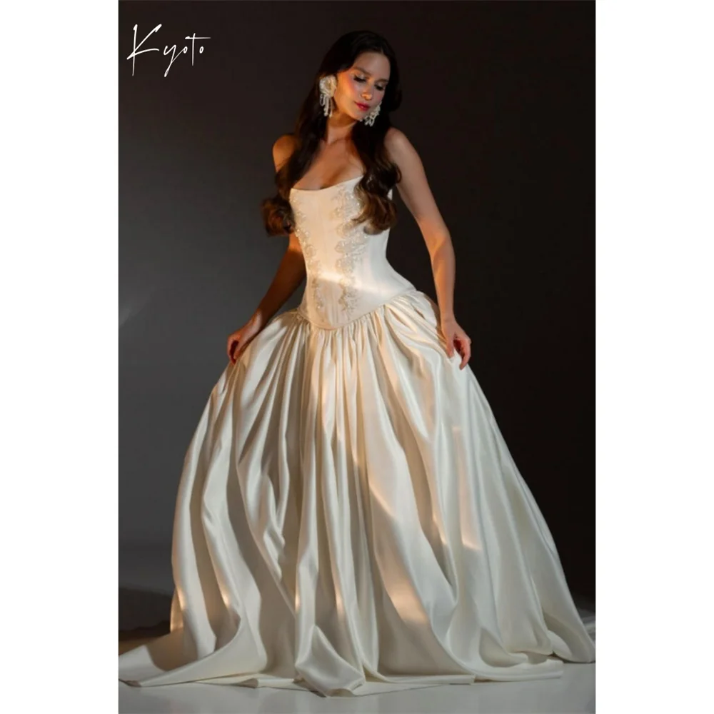 Свадебное платье Kyoto, белое, без бретелек, с кружевной шнуровкой на спине, фасон А-силуэт, из атласа, вечернее, 2026
Свадебное платье Kyoto, белое, без бретелек, с кружевной шнуровкой на спине, фасон А-силуэт, из атласа, вечернее, 2026