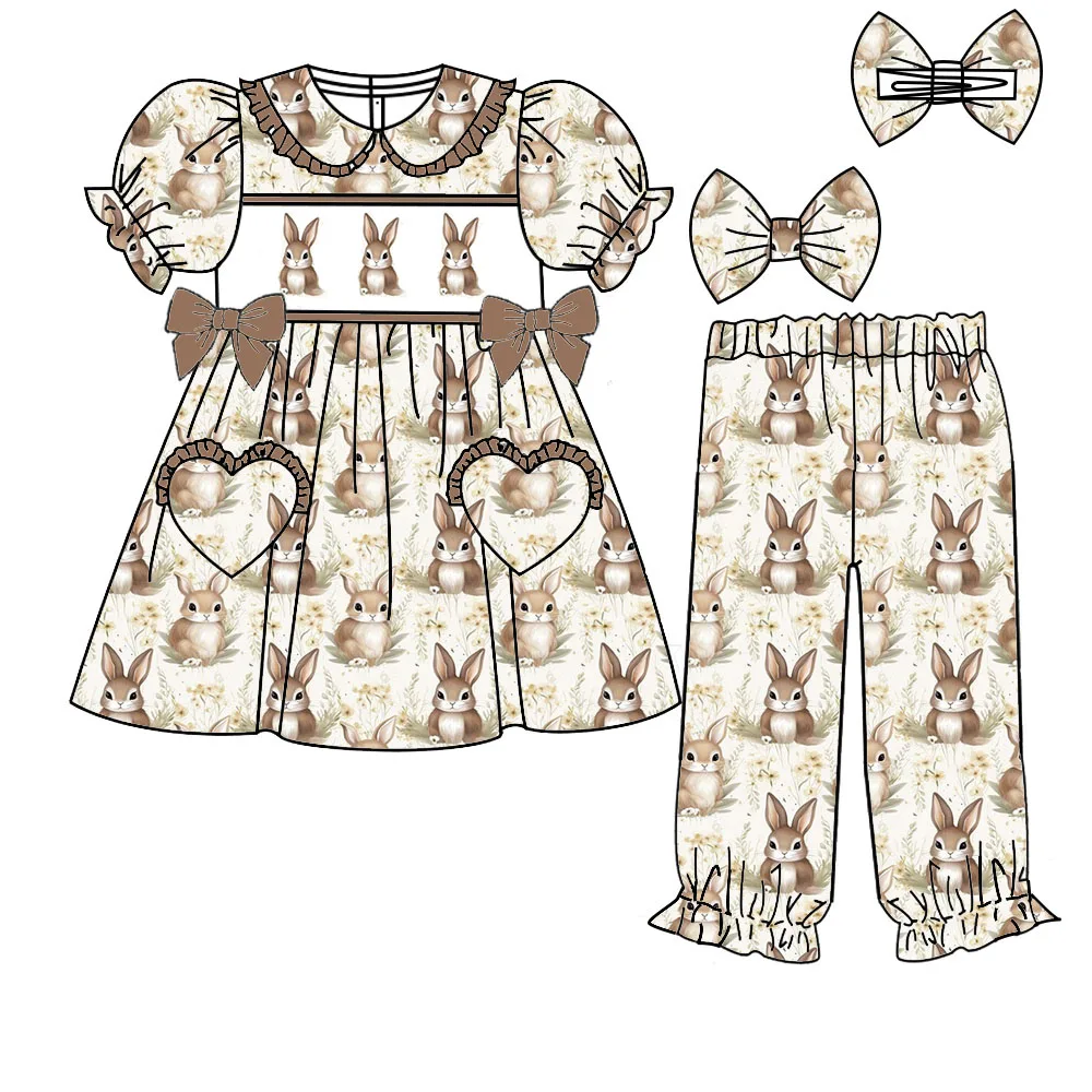 New Easter-themed girls' yellow and blue rabbit, egg, and floral print pajama set with ruffled corsage.
New Easter-themed girls' yellow and blue rabbit, egg, and floral print pajama set with ruffled corsage.