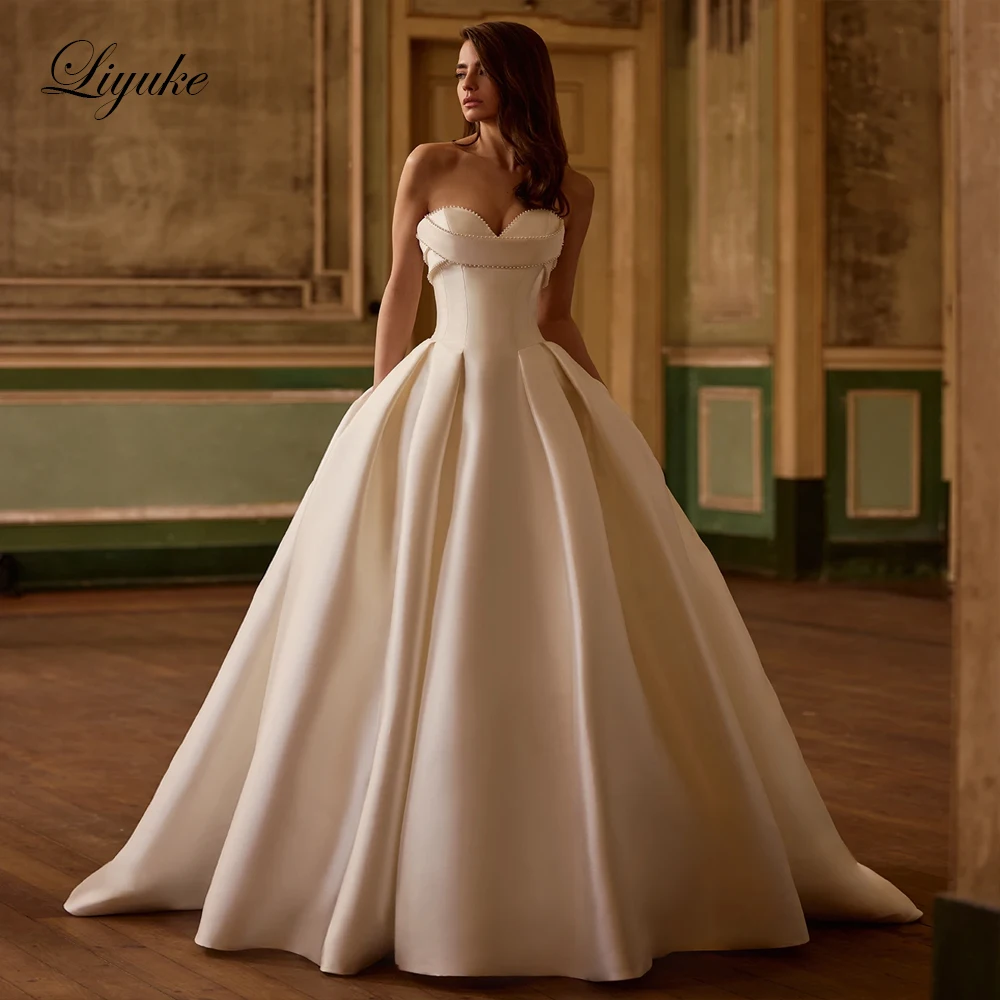Liyuke Custom Made Elegant Sleeveless Puffy Ball Gown Wedding Dresses With Beaded Pearls Gorgeous Satin Sweetheart Bridal Gowns
Liyuke Custom Made Elegant Sleeveless Puffy Ball Gown Wedding Dresses With Beaded Pearls Gorgeous Satin Sweetheart Bridal Gowns