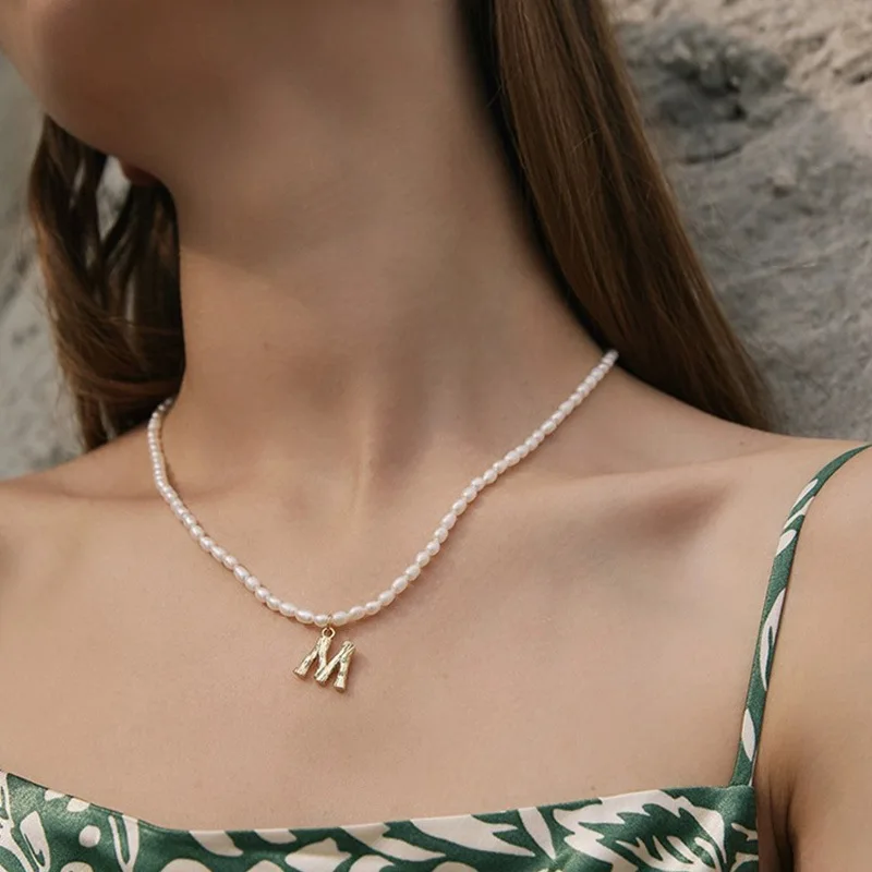 Classic Retro Bamboo Pattern Letter Charming Necklace for Women Natural Pearl Strand Chain Gold-plated 26 Letters Clavicle Chain
Classic Retro Bamboo Pattern Letter Charming Necklace for Women Natural Pearl Strand Chain Gold-plated 26 Letters Clavicle Chain