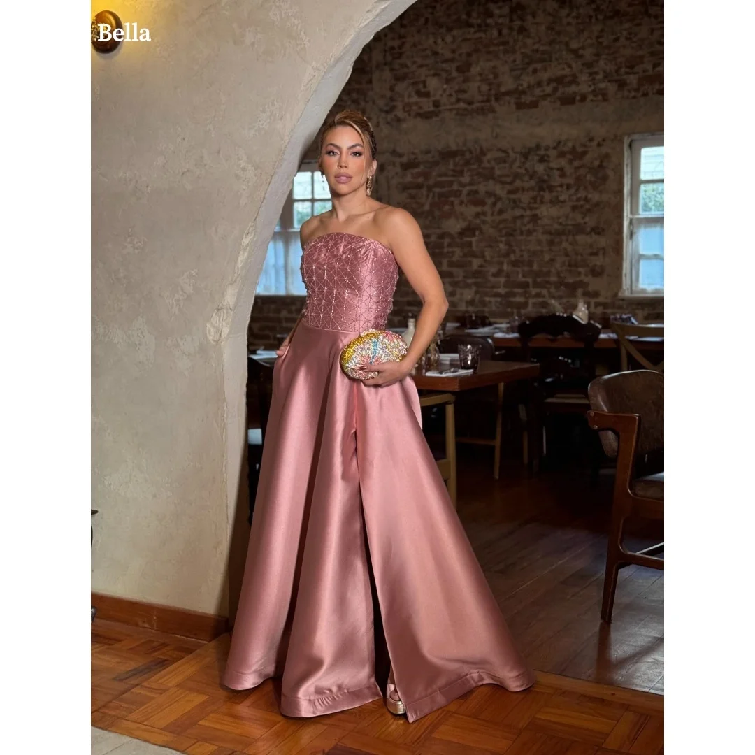 Bella Customized Blush Pink Strapless Prom Dress with Beaded Embellished Bodice and Voluminous Satin Ball Gown Skirt with Pocket
Bella Customized Blush Pink Strapless Prom Dress with Beaded Embellished Bodice and Voluminous Satin Ball Gown Skirt with Pocket