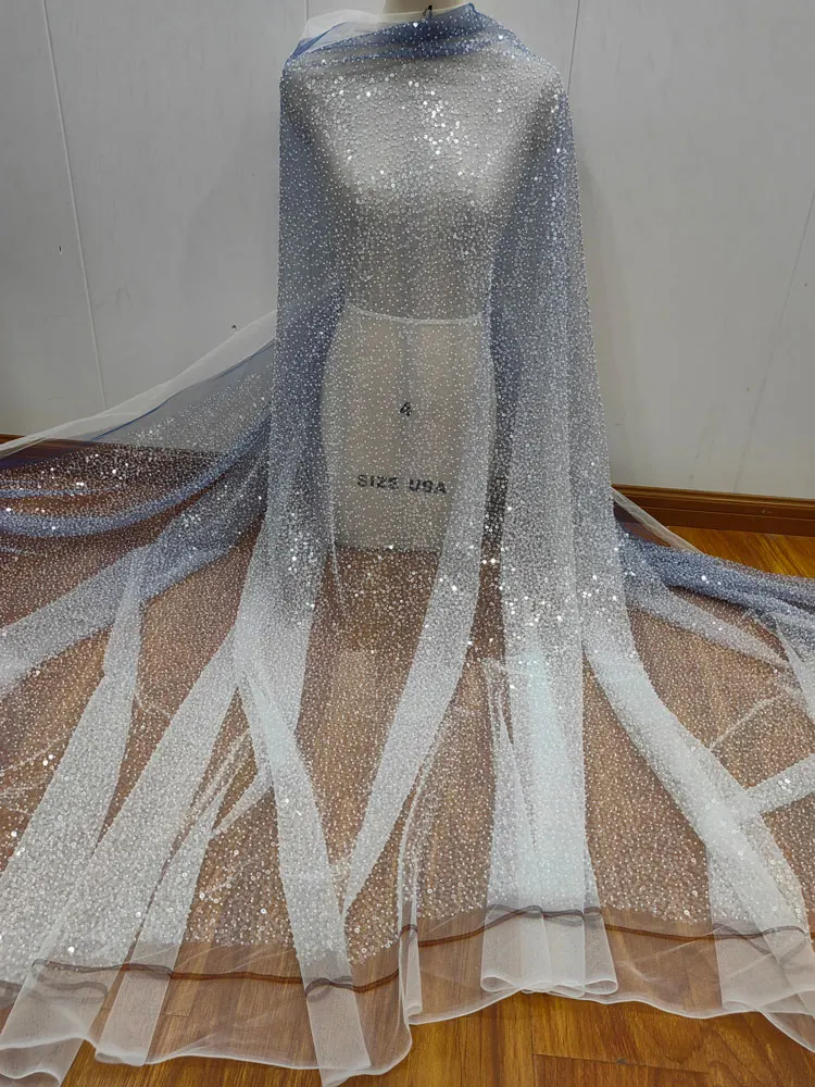 Light Blue See Through Mesh Fabric with Gradient Blue and Sequins Accents Is Used for Customized Wedding Dresses and Other Items
Light Blue See Through Mesh Fabric with Gradient Blue and Sequins Accents Is Used for Customized Wedding Dresses and Other Items