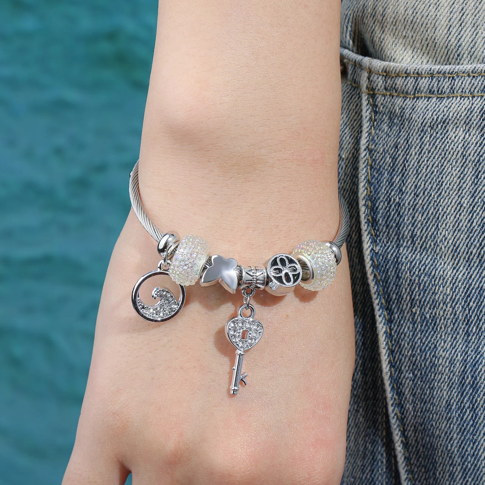 Silver Tone Charm Bangle with Wave and Key Pendant for Women
Silver Tone Charm Bangle with Wave and Key Pendant for Women