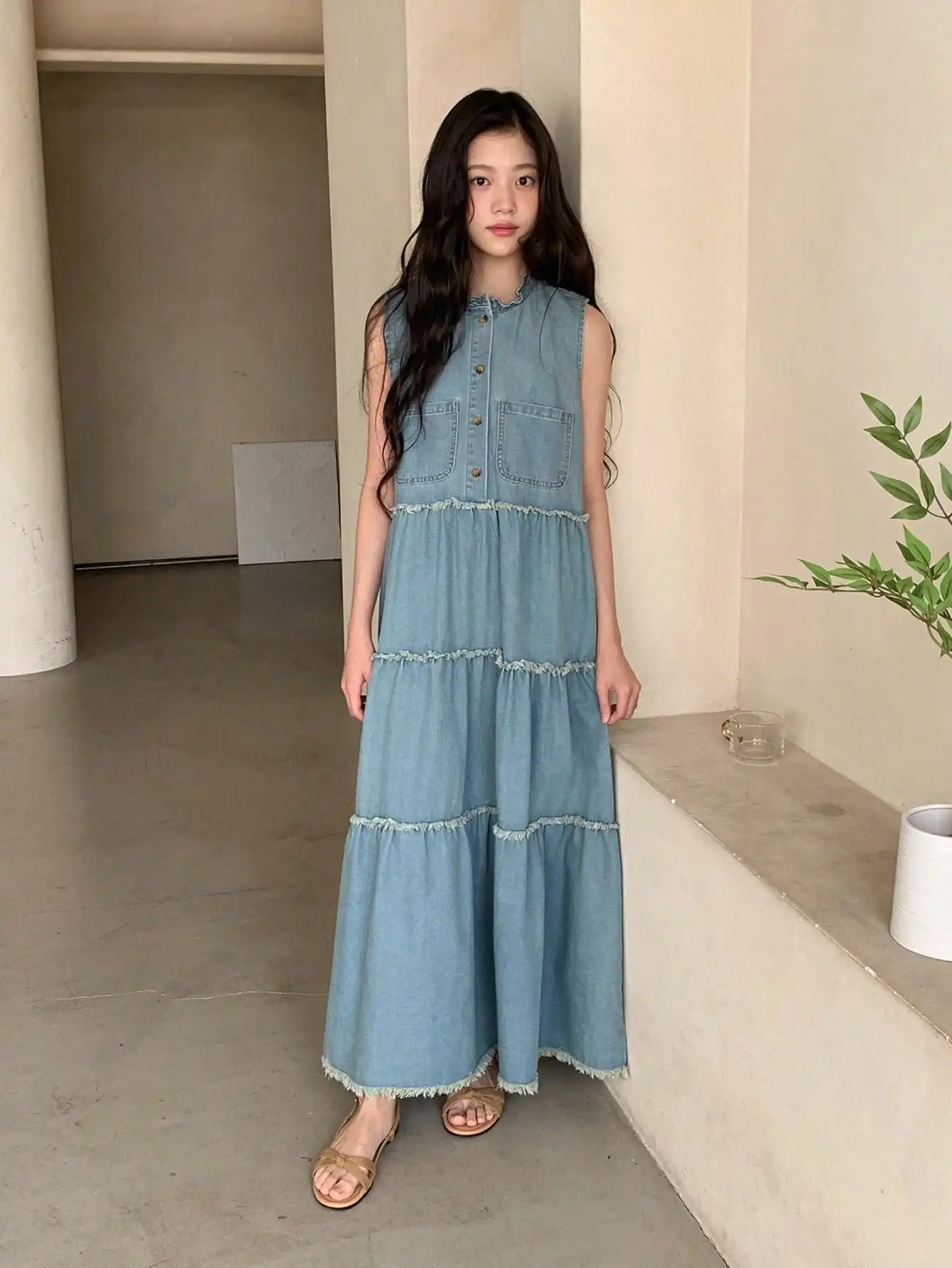 Sleeveless Denim Maxi Dress With Mandarin Collar And Tiered Ruffle Hem
Sleeveless Denim Maxi Dress With Mandarin Collar And Tiered Ruffle Hem