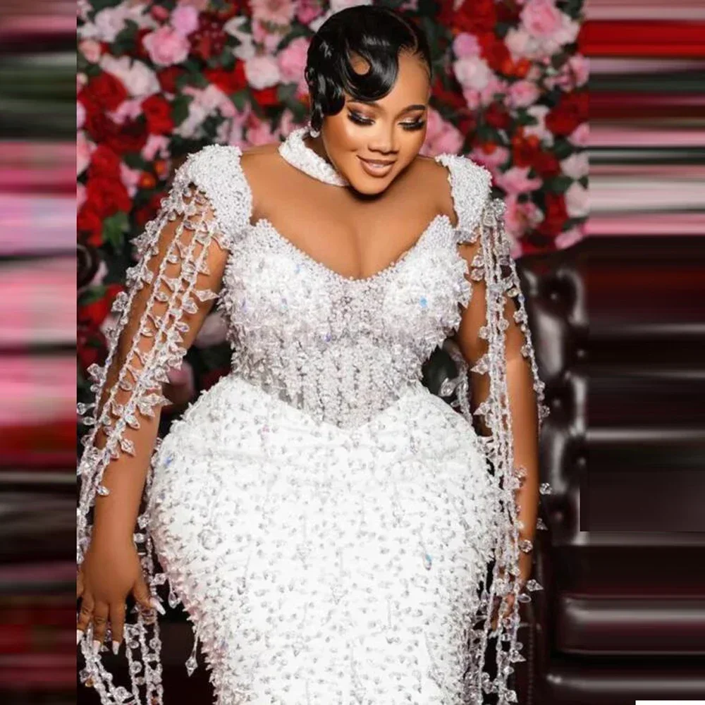 Customized Arabic Plus Size Luxury Beads Pearls Mermaid Wedding Dress Aso Ebi High Collar Bridal Gown with Cape Tassels
Customized Arabic Plus Size Luxury Beads Pearls Mermaid Wedding Dress Aso Ebi High Collar Bridal Gown with Cape Tassels