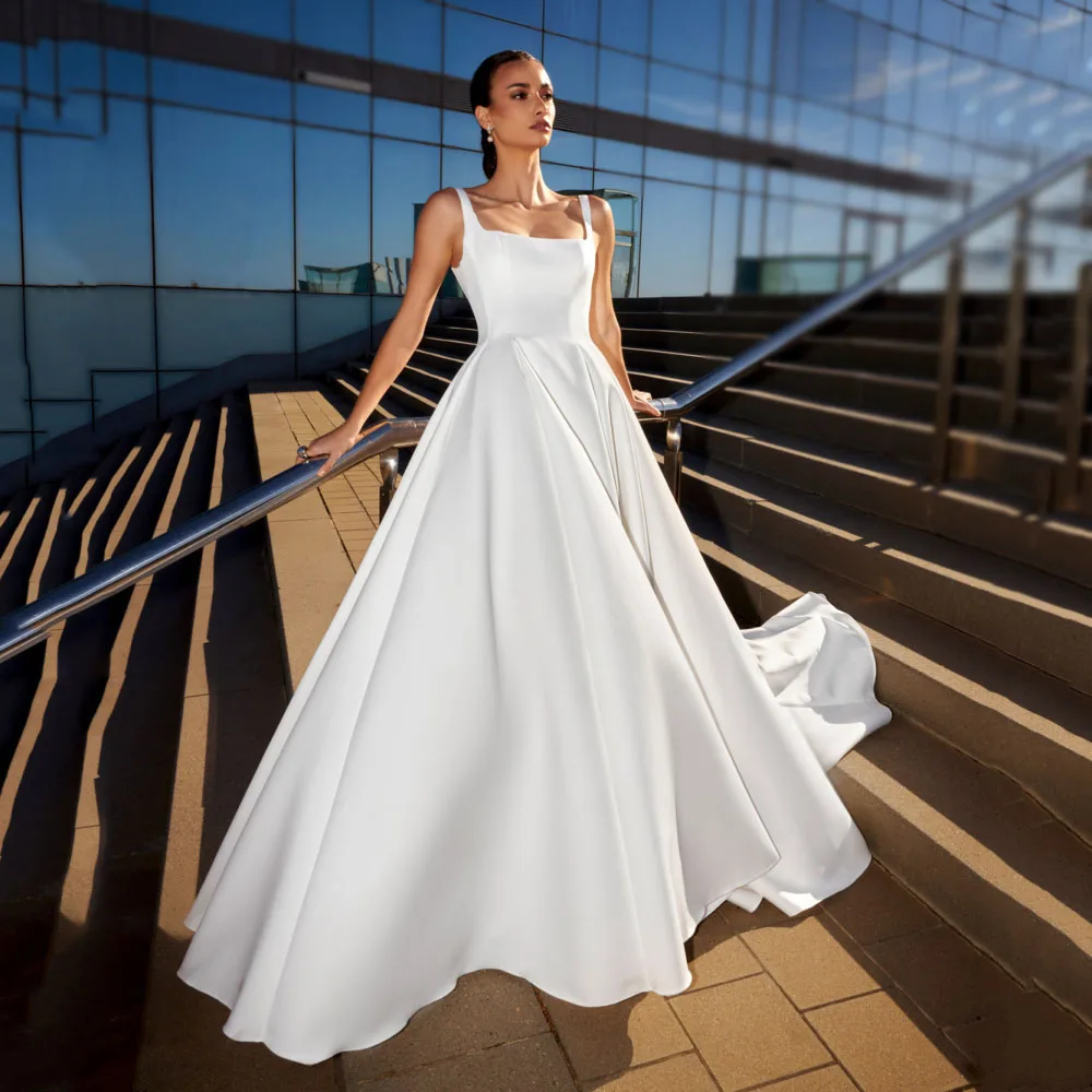 Customized Square Neck Satin Wedding Dresses 2026 Button Classic Brides Gown A-Line Sleeveless Simple Bridal Dresses
Customized Square Neck Satin Wedding Dresses 2026 Button Classic Brides Gown A-Line Sleeveless Simple Bridal Dresses