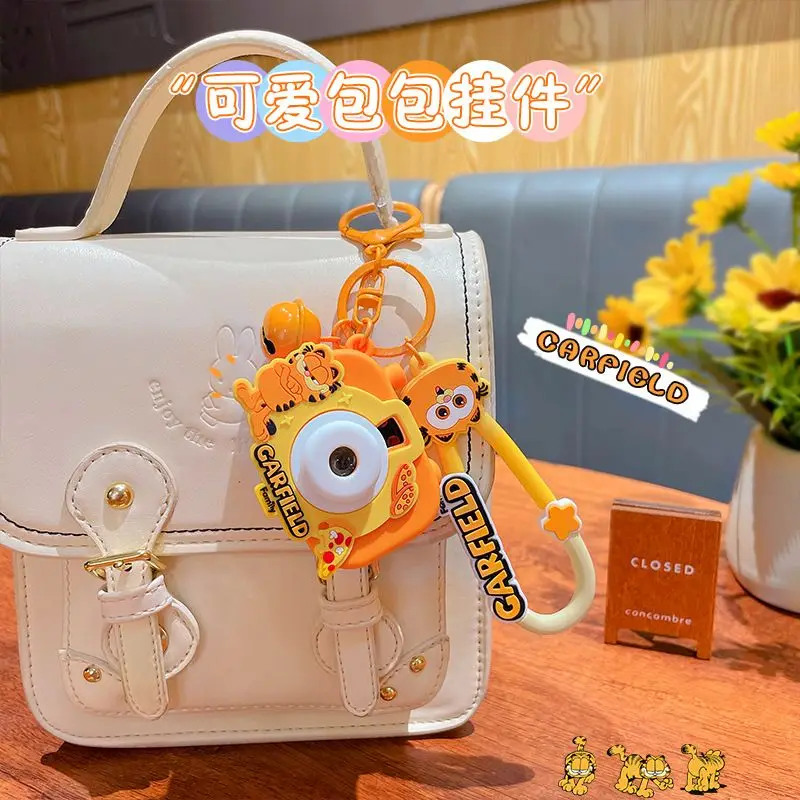 Cartoon Garfield projection camera keychain cute backpack bell pendant for girls room decoration children's toy gift
Cartoon Garfield projection camera keychain cute backpack bell pendant for girls room decoration children's toy gift