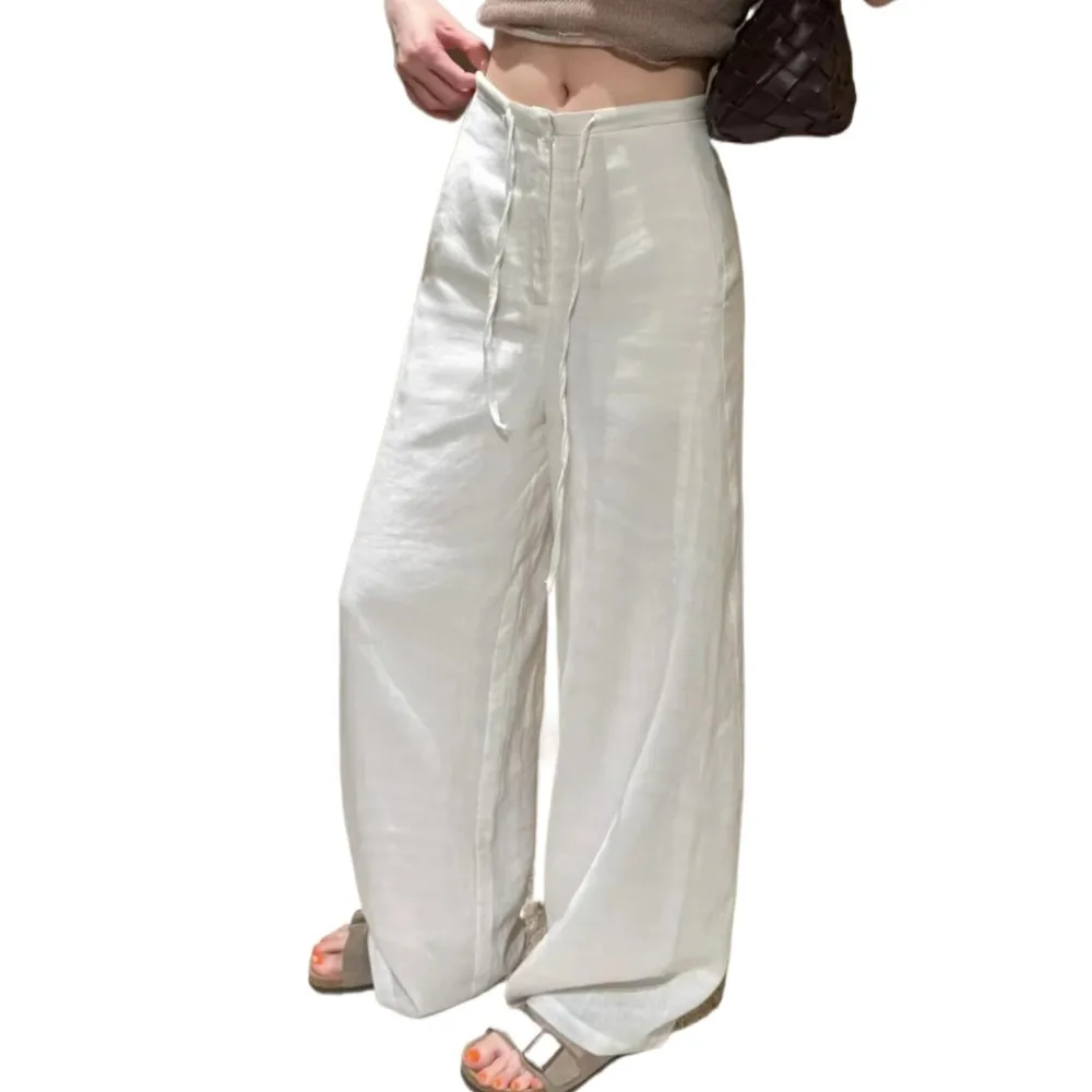 Лето 2025 г., белые, темно-синие льняные широкие брюки, женские свободные повседневные брюки с эластичной резинкой на талии и веревкой, длиной до пола, брюки
Лето 2025 г., белые, темно-синие льняные широкие брюки, женские свободные повседневные брюки с эластичной резинкой на талии и веревкой, длиной до пола, брюки
