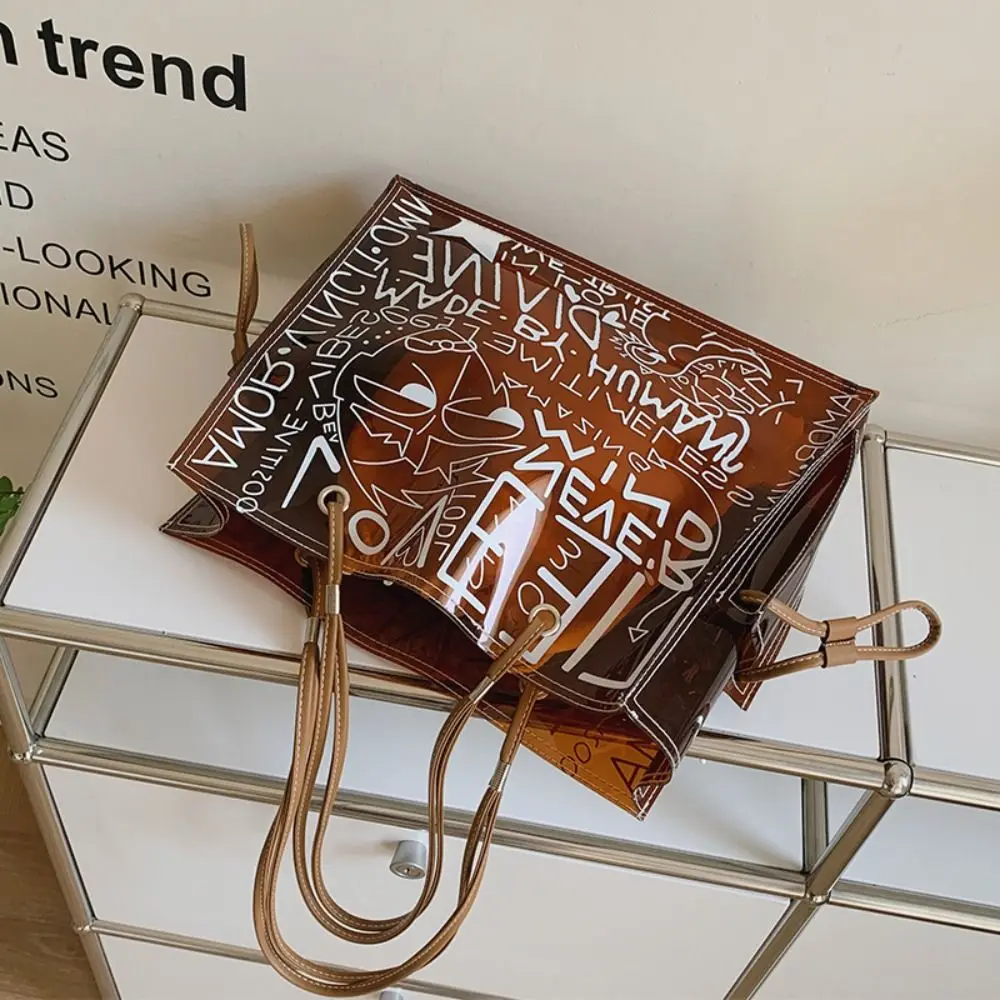 Creative Graffiti Transparent Tote Bag Waterproof Portable Shoulder Bag Large Capacity PVC Jelly Clear Bag Women
Creative Graffiti Transparent Tote Bag Waterproof Portable Shoulder Bag Large Capacity PVC Jelly Clear Bag Women