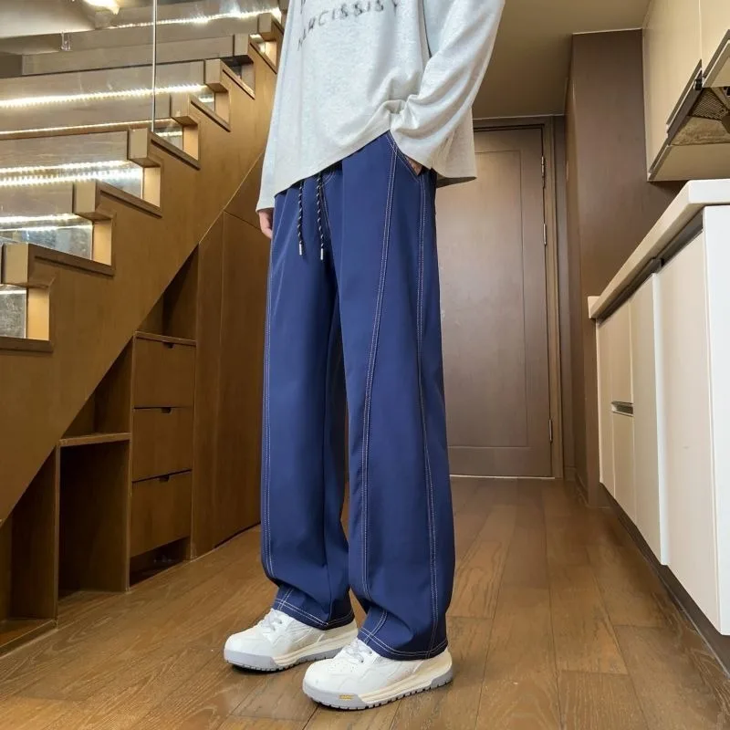 Мужские широкие брюки с завязками на талии, контрастной строчкой, свободного кроя, повседневные.
Мужские широкие брюки с завязками на талии, контрастной строчкой, свободного кроя, повседневные.