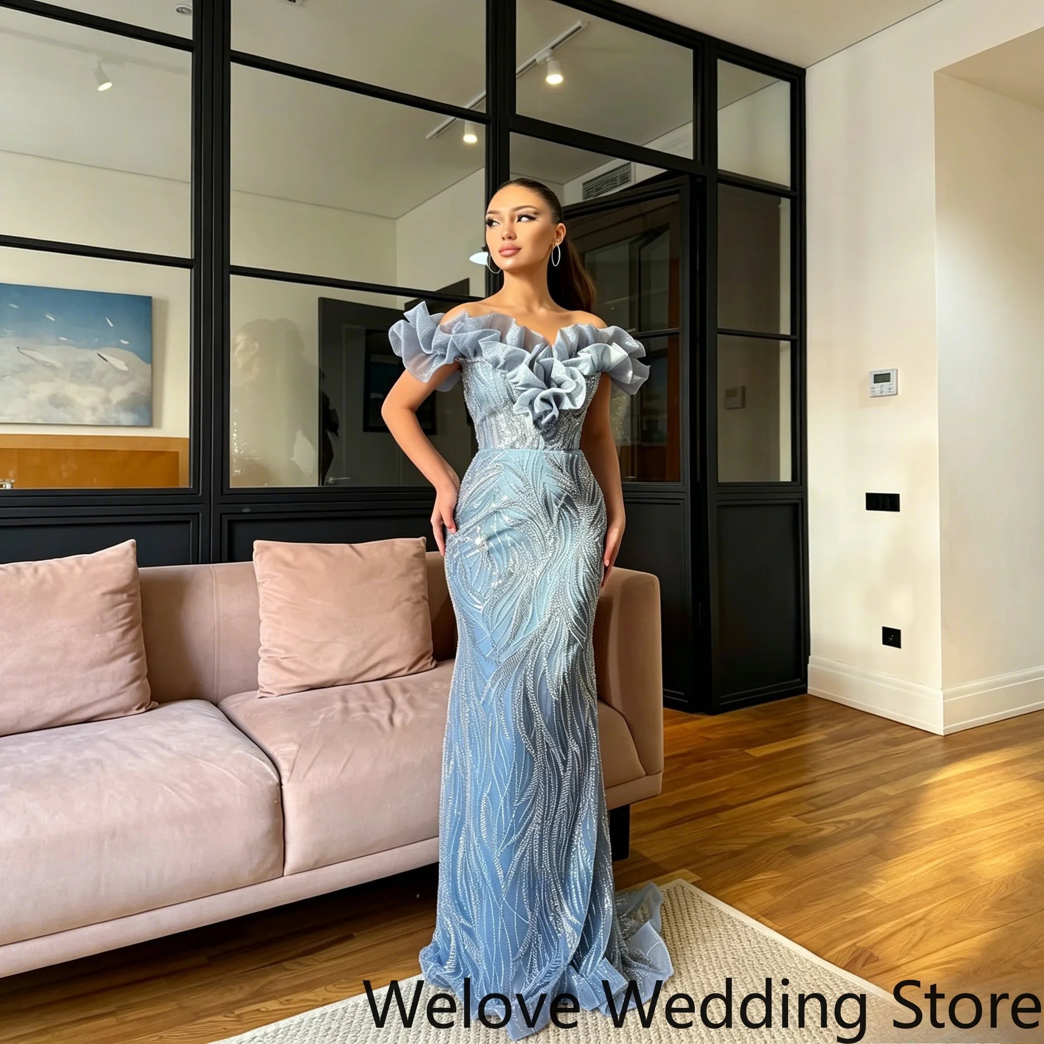 Glamorous light blue mermaid evening gown with off‑the‑shoulder oversized ruffle neckline, full‑body sparkling beaded detailing
Glamorous light blue mermaid evening gown with off‑the‑shoulder oversized ruffle neckline, full‑body sparkling beaded detailing