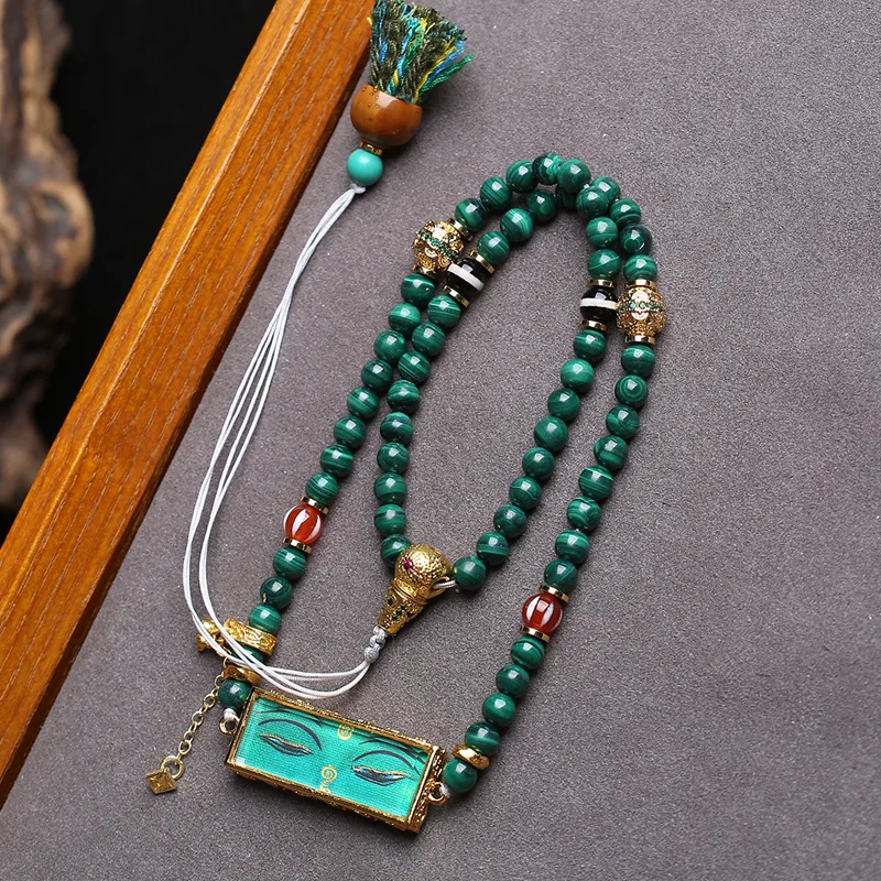 Natural malachite necklace with agate, purple gold rat charm and Green Tara thangka pendant, worn as a choker
Natural malachite necklace with agate, purple gold rat charm and Green Tara thangka pendant, worn as a choker