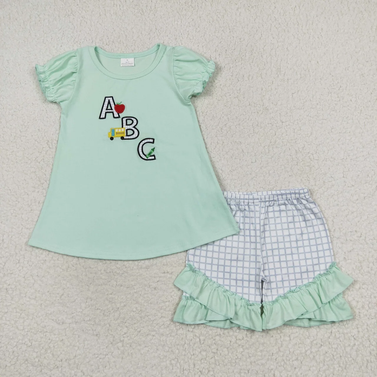 Wholesale Toddler Back to School Baby Girl Embroidery Outfit Children Short Sleeves Green Cotton Tops Plaid Shorts Kids Set
Wholesale Toddler Back to School Baby Girl Embroidery Outfit Children Short Sleeves Green Cotton Tops Plaid Shorts Kids Set