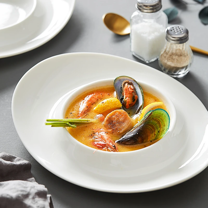 Белая керамическая тарелка неправильной формы для супа в гостиницах, ресторанах, китайская посуда, кухонная тарелка для холодного салата
Белая керамическая тарелка неправильной формы для супа в гостиницах, ресторанах, китайская посуда, кухонная тарелка для холодного салата