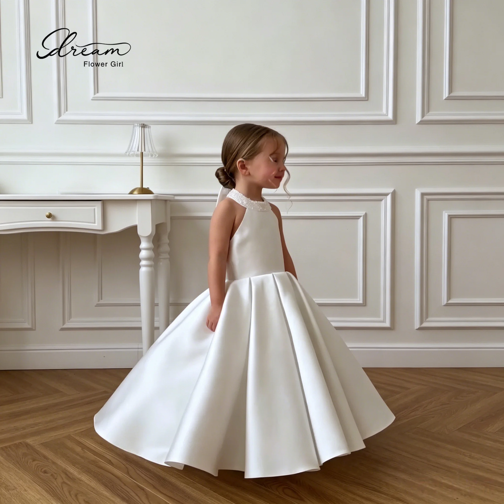 White floor-length sleeveless halter-neck princess-style formal ball gown for girls featuring a full voluminous skirt
White floor-length sleeveless halter-neck princess-style formal ball gown for girls featuring a full voluminous skirt