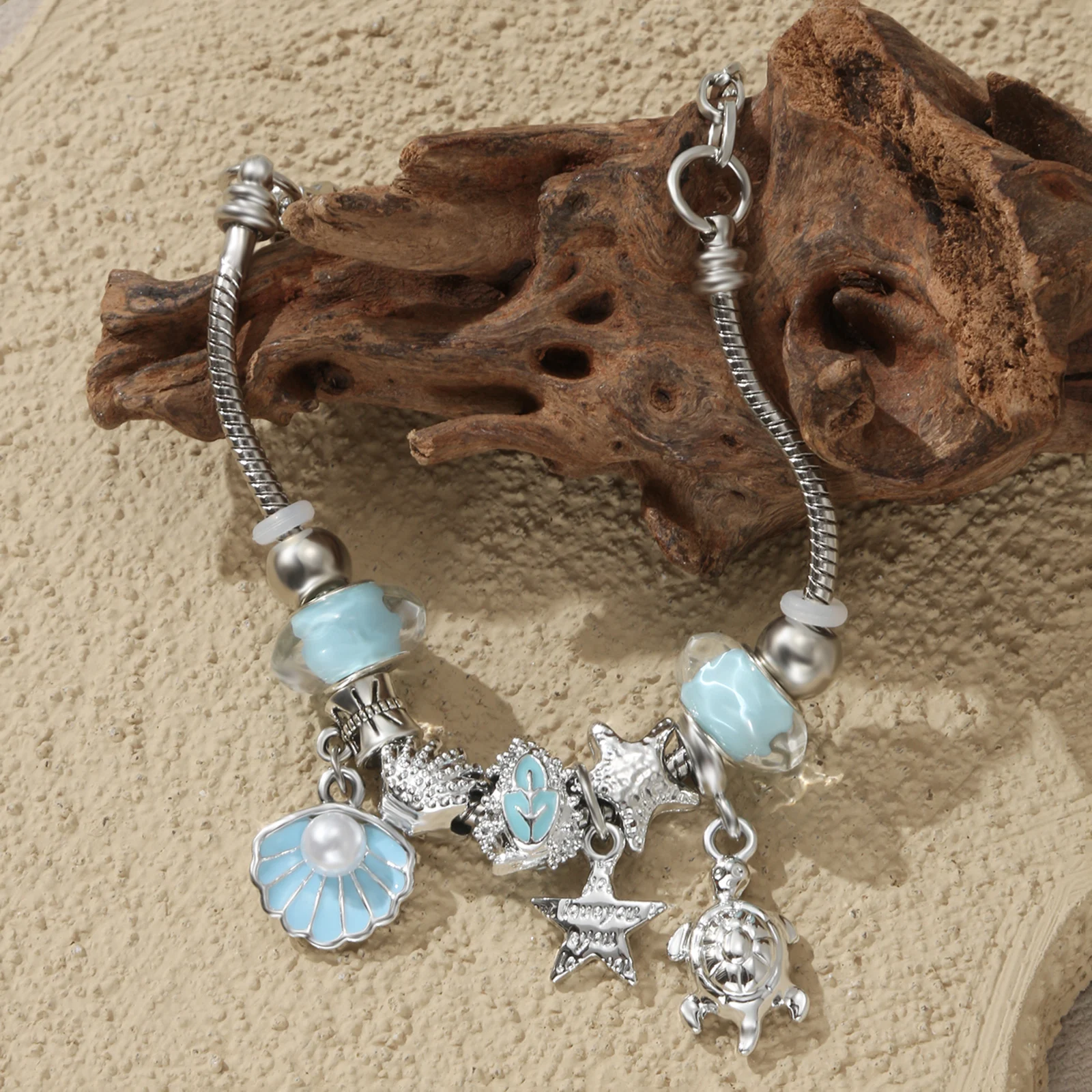 Silver Tone Ocean Theme Charm Bracelet with Turtle and Shell Pendant for Women
Silver Tone Ocean Theme Charm Bracelet with Turtle and Shell Pendant for Women