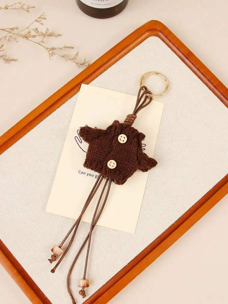 Knitted Sweater Mini Bag Charm With Beaded Tassels And Button Detail
Knitted Sweater Mini Bag Charm With Beaded Tassels And Button Detail