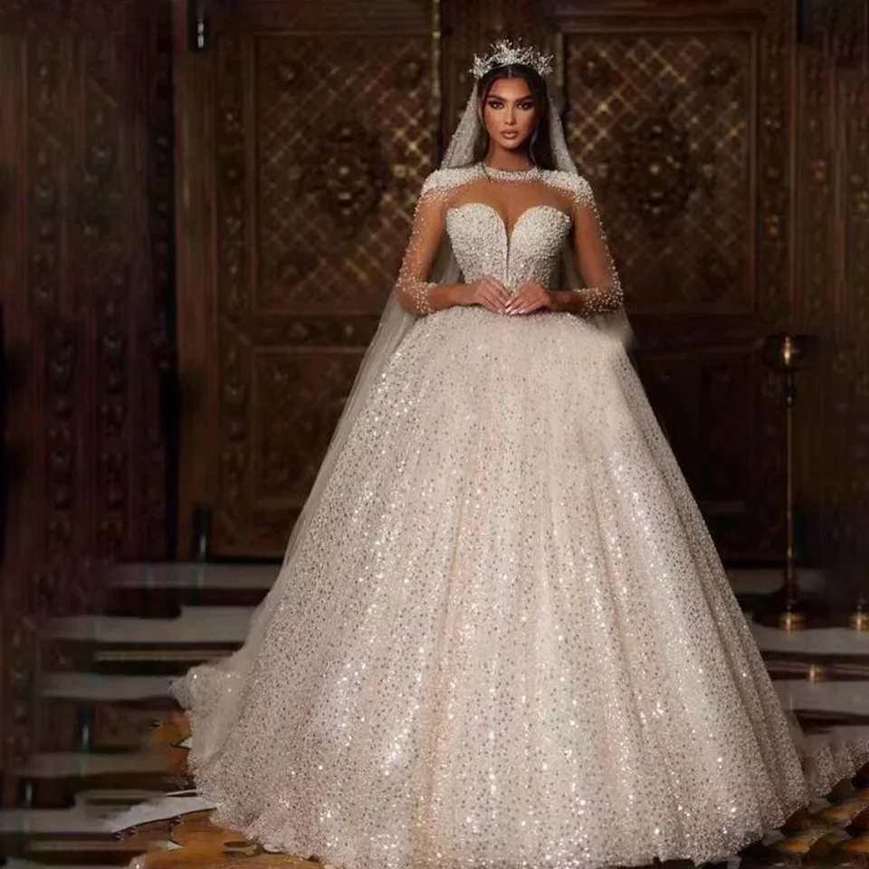Customized Luxurious Sequin Beaded Crystal Wedding Dresses Illusion Long Sleeves O-Neck Court Train Bridal Gown
Customized Luxurious Sequin Beaded Crystal Wedding Dresses Illusion Long Sleeves O-Neck Court Train Bridal Gown