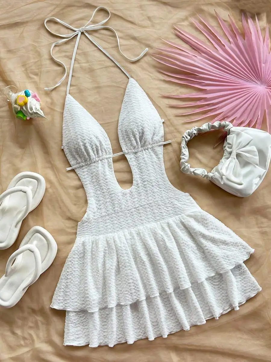 White Textured Halter Neck Mini Dress with Cutout, Ruffle Hem & Tie Waist
White Textured Halter Neck Mini Dress with Cutout, Ruffle Hem & Tie Waist