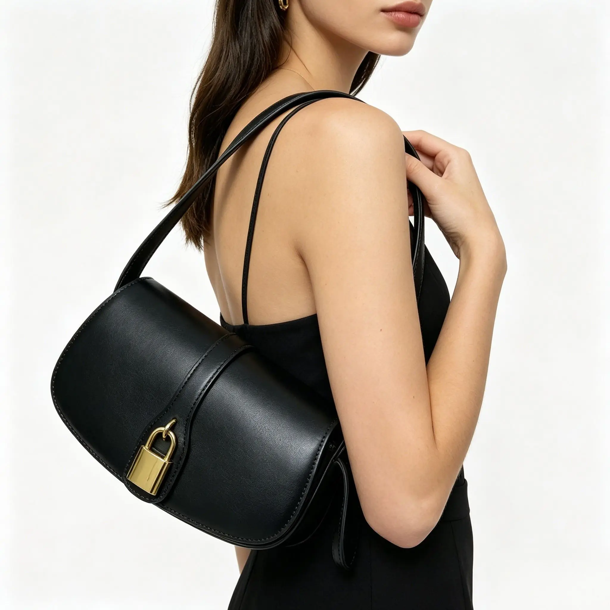 Black genuine leather shoulder bag with gold-tone lock closure and minimalist saddle design.
Black genuine leather shoulder bag with gold-tone lock closure and minimalist saddle design.