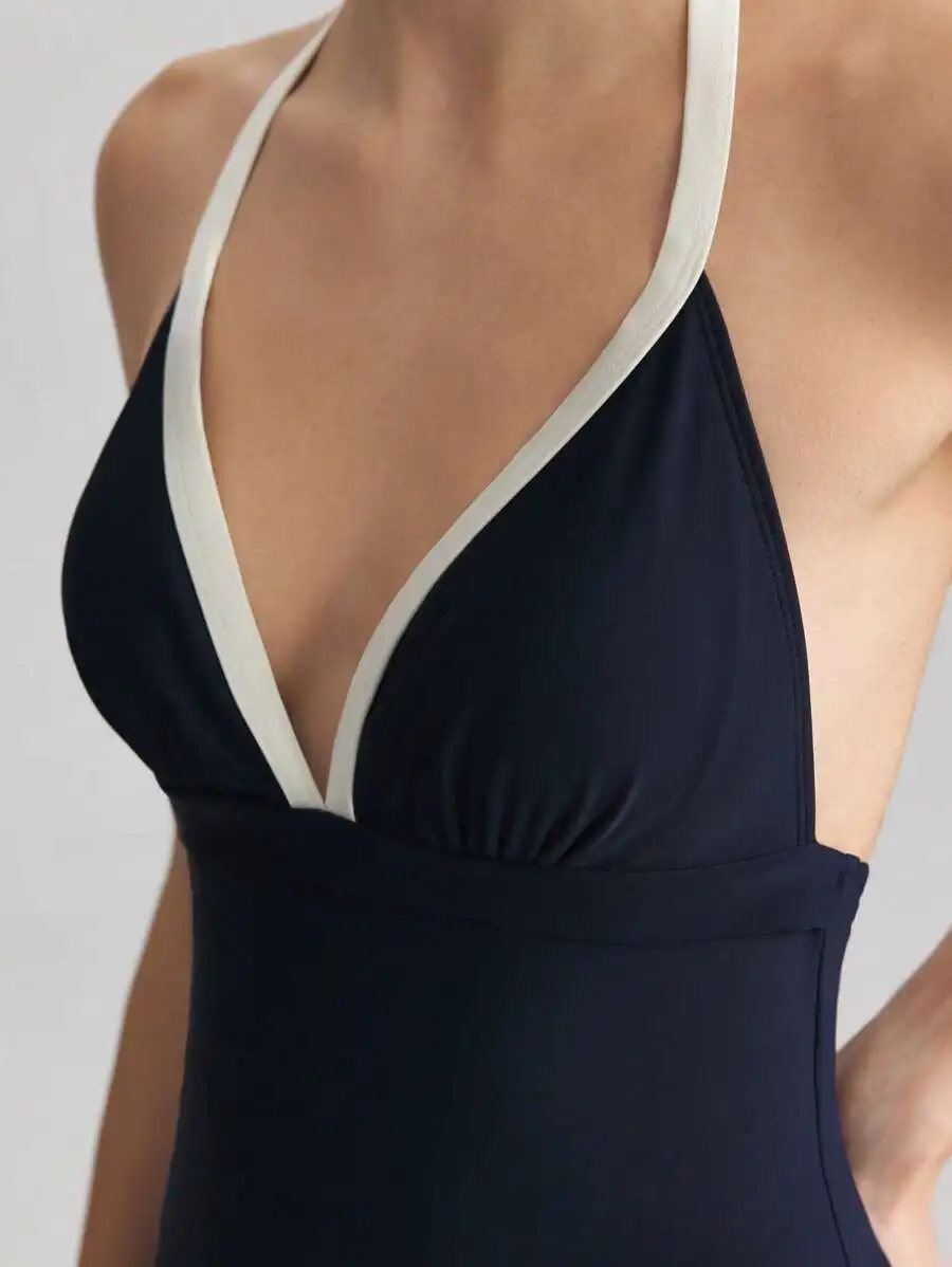 Blue One-Piece Swimsuit With Apricot Contrast Halter Neck Boyleg Design
Blue One-Piece Swimsuit With Apricot Contrast Halter Neck Boyleg Design