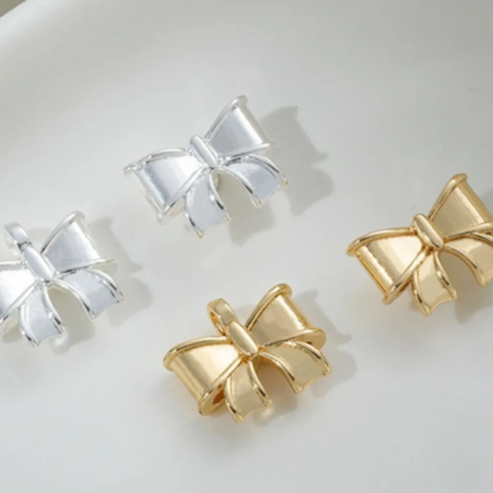 Copper 14K Gold Color String Hole Three-dimensional Bow Hanging Hole Bow Tie Pendant DIY Handmade String Accessories Material
Copper 14K Gold Color String Hole Three-dimensional Bow Hanging Hole Bow Tie Pendant DIY Handmade String Accessories Material