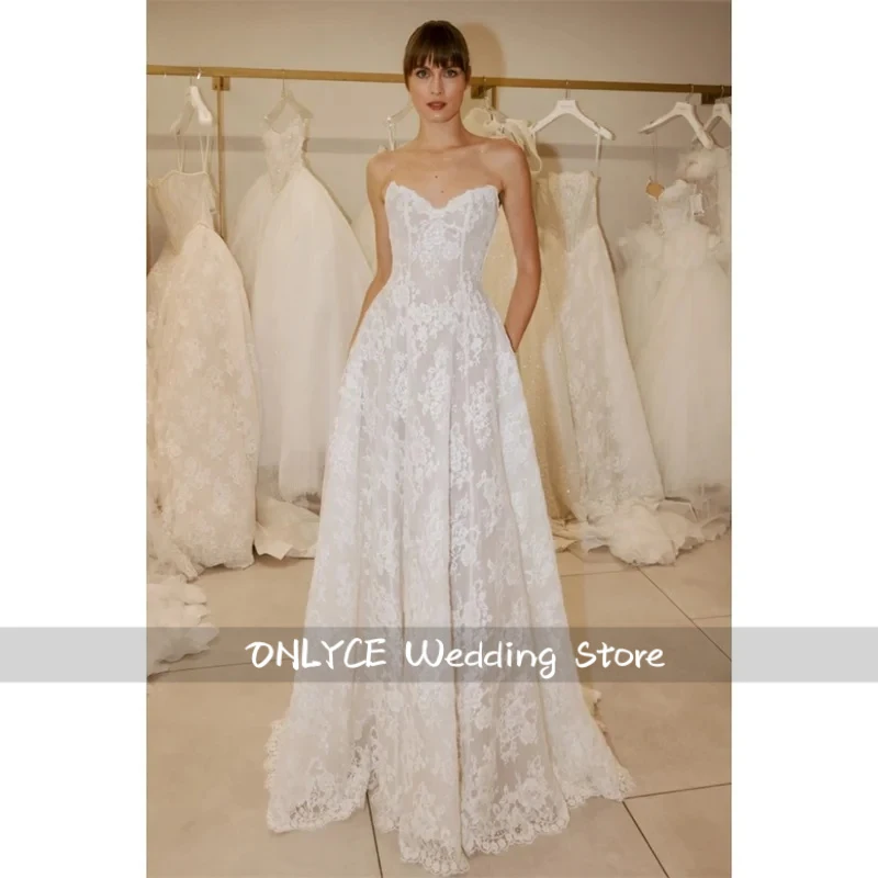 A-Line Customized White Wedding Dresses Zip Back Court Train vestidos de noche Strapless Sleeveless robe de mariée 2026
A-Line Customized White Wedding Dresses Zip Back Court Train vestidos de noche Strapless Sleeveless robe de mariée 2026