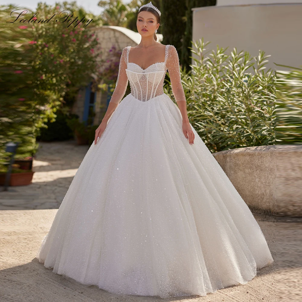 Lceland Poppy Customized Ball Gown Wedding Dresses See Through 3/4 Sleeves Beaded Lace Bridal Gowns with Court Train
Lceland Poppy Customized Ball Gown Wedding Dresses See Through 3/4 Sleeves Beaded Lace Bridal Gowns with Court Train