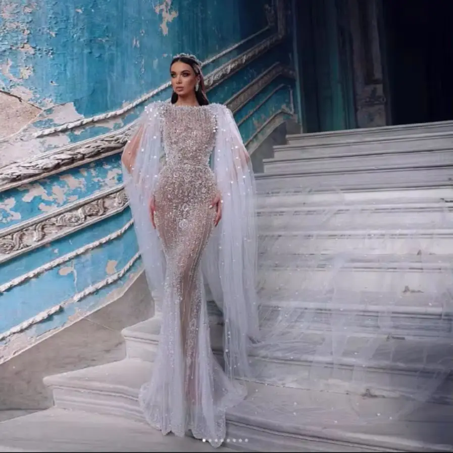 Lush Pearls Tulle Mermaid Saudi Arabic Wedding Gowns Cloak Crystal Beads Wedding Gown Vestidos de noiva Dubai Bridal Dresses
Lush Pearls Tulle Mermaid Saudi Arabic Wedding Gowns Cloak Crystal Beads Wedding Gown Vestidos de noiva Dubai Bridal Dresses