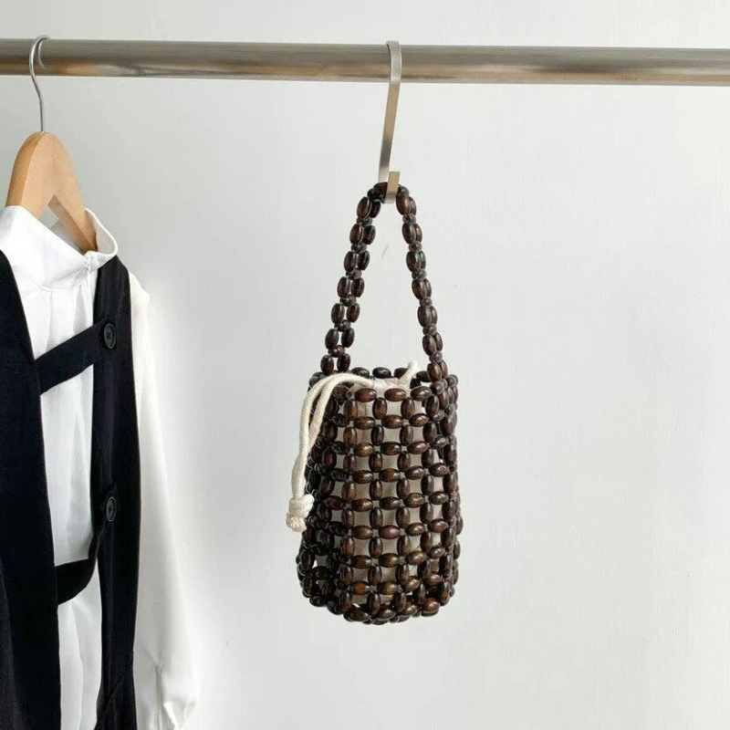 New Wooden Bead Woven Mini Handbag for Ladies, Ideal for Seaside Vacation, Retro Hollowed-out Bead-stringed Handbag for Carrying
New Wooden Bead Woven Mini Handbag for Ladies, Ideal for Seaside Vacation, Retro Hollowed-out Bead-stringed Handbag for Carrying