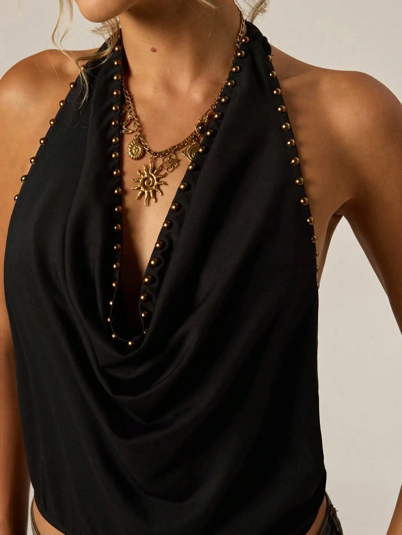 Black Halter Neck Top with Gold Studs, Deep V Neckline, Draped Design for Night Out or Festival
Black Halter Neck Top with Gold Studs, Deep V Neckline, Draped Design for Night Out or Festival