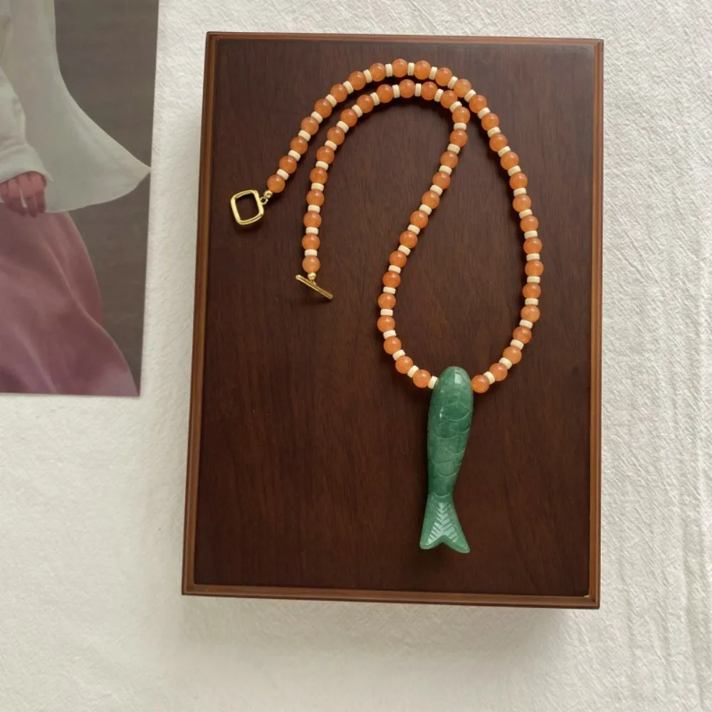 Trendy Green Jade Carved Fish Pendant Necklace, Simple and Fashionable, Niche Vacation Style Orange Stone Beaded Clavicle Chain
Trendy Green Jade Carved Fish Pendant Necklace, Simple and Fashionable, Niche Vacation Style Orange Stone Beaded Clavicle Chain